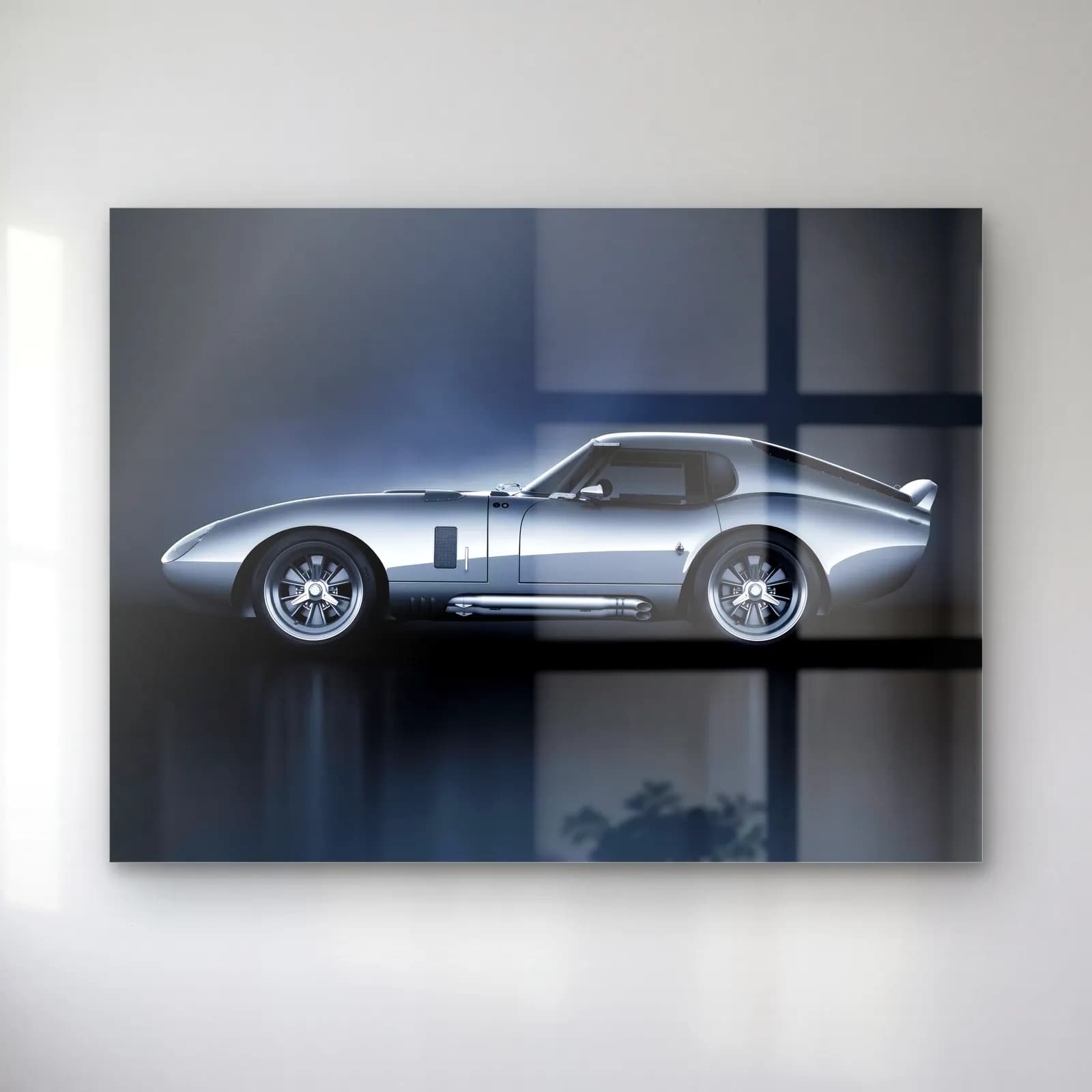 Gümüş Shelby Daytona Coupe cam tablo — Mavi gri fonda yan profilden görünen gümüş renkli Shelby Daytona Coupe
